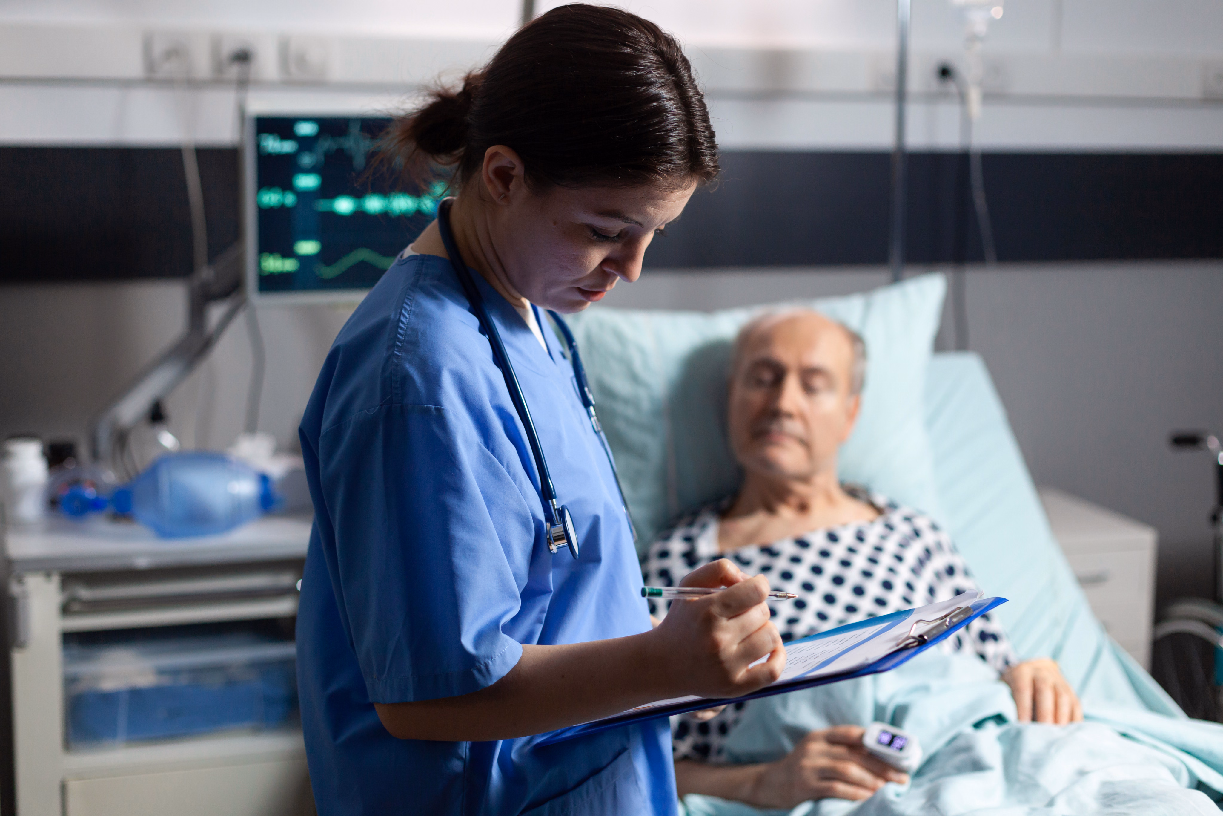 Nurse at a patient's bedside